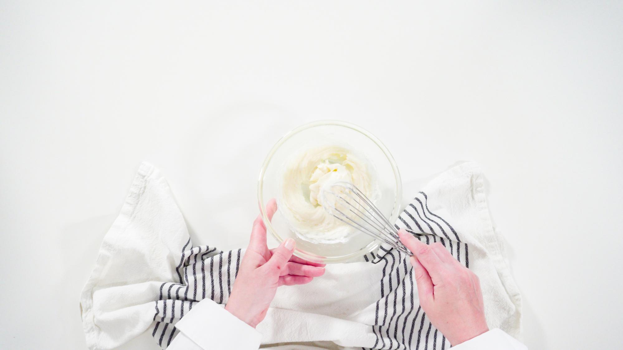 Close-up of hands preparing dessert